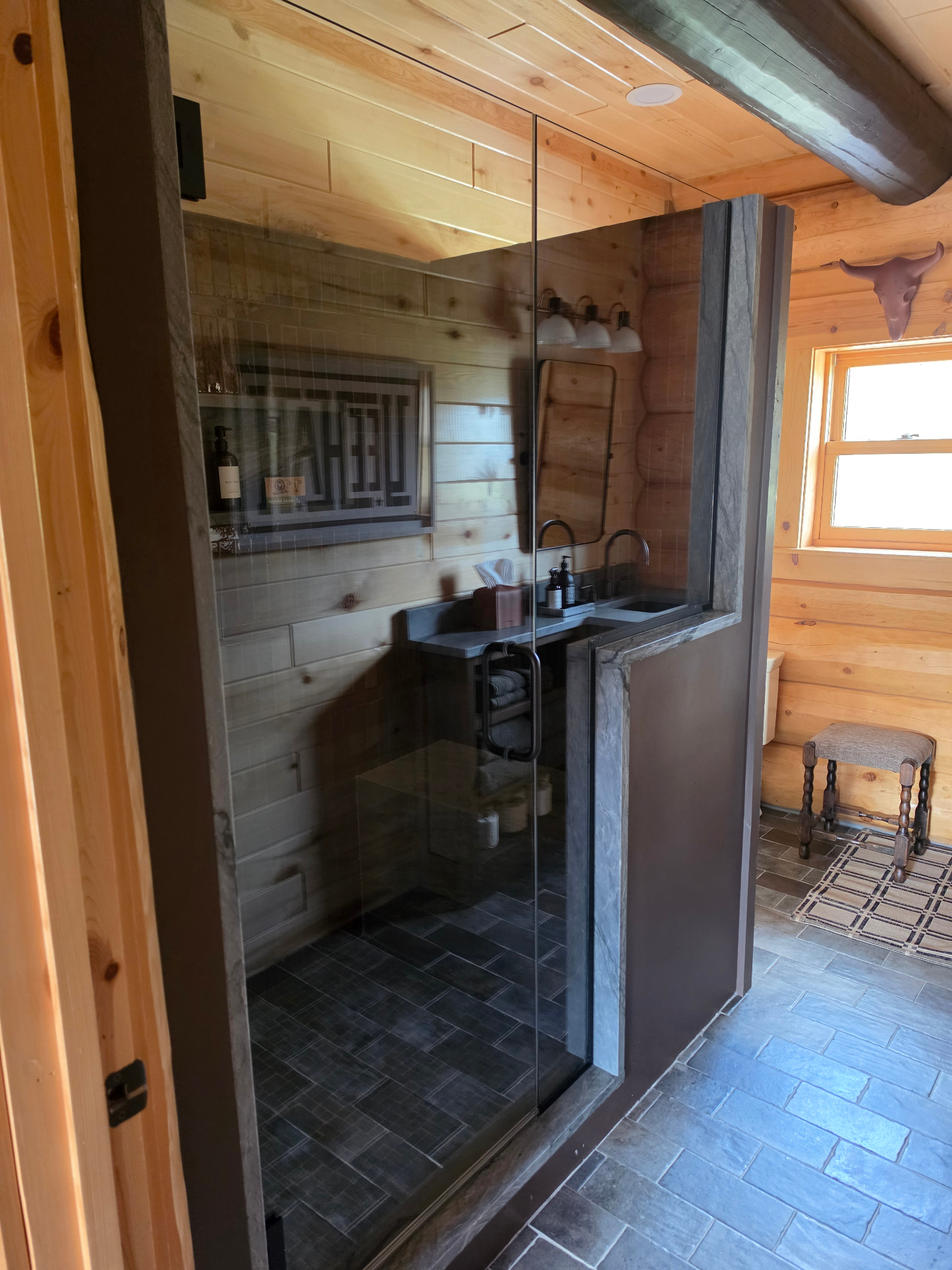 Frameless walk-in shower in a log-home Airbnb in Paonia, Colorado