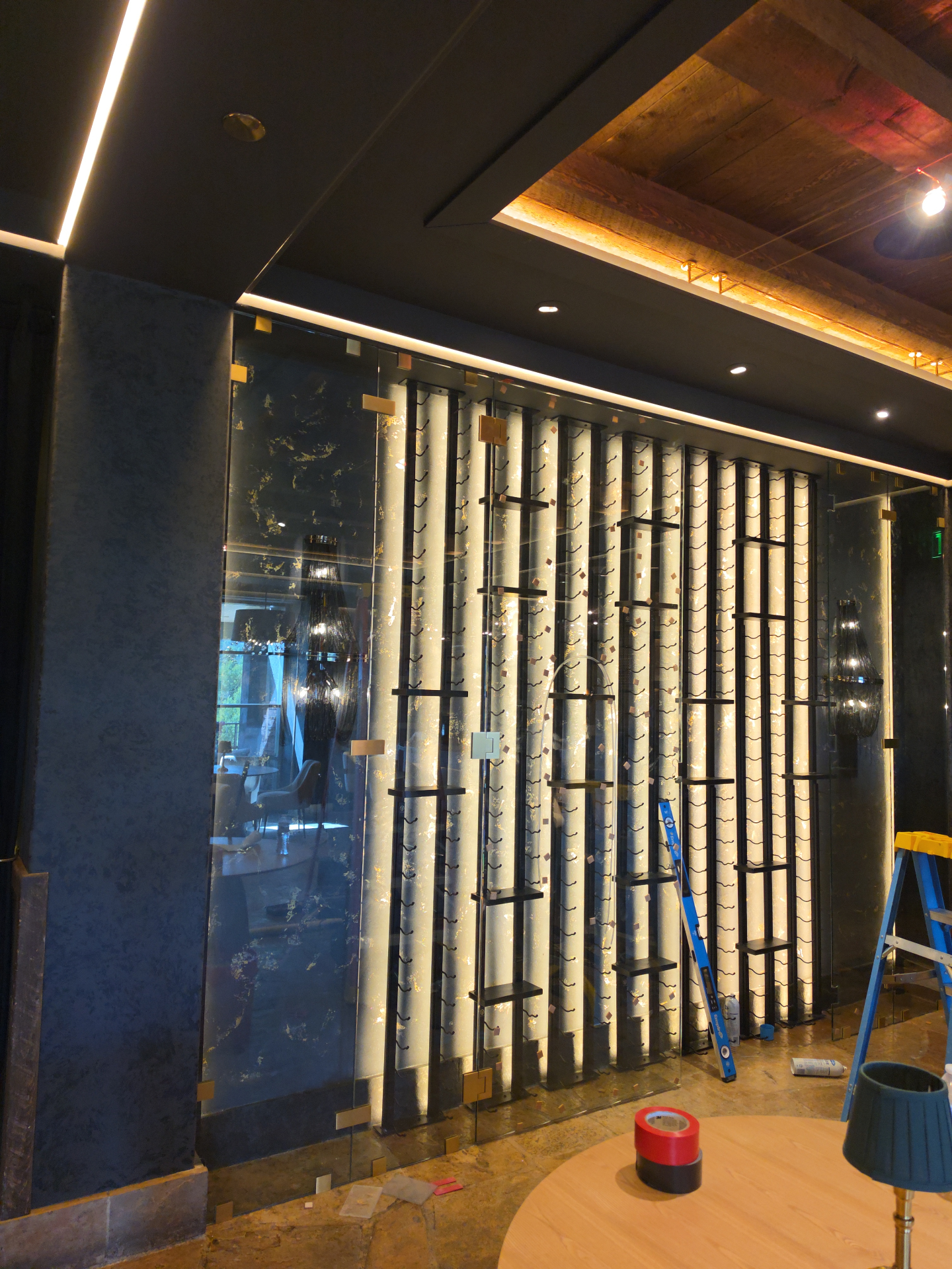 Frameless glass wine room enclosure with brass clips at The Peaks in Mountain Village, Colorado